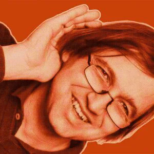 Red-filtered portrait of Andreas from DAVID Systems smiling and holding his right hand behind his ear