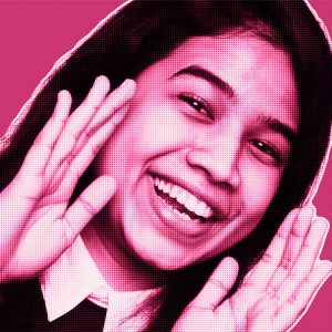 Pink-filtered portrait of Aysha from DAVID Systems smiling and holding both her hands to the side of her face