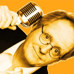 Yellow-filtered portrait of James from DAVID Systems holding a microphone to the side of his head with his right hand
