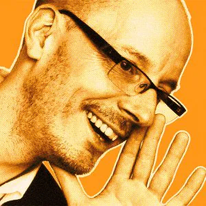 Orange-filtered portrait of Michael B. smiling and holding his hand to his mouth