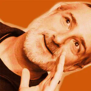 Orange-filtered portrait of Thomas from DAVID Systems looking to the side and holding his left hand to the side of his face