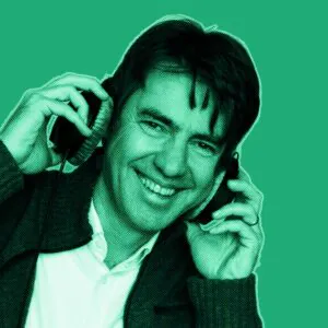 Jorg holding a headset on his ears in a green filter