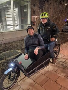 Albert sitting in a cargobike, which is driven by Vincent